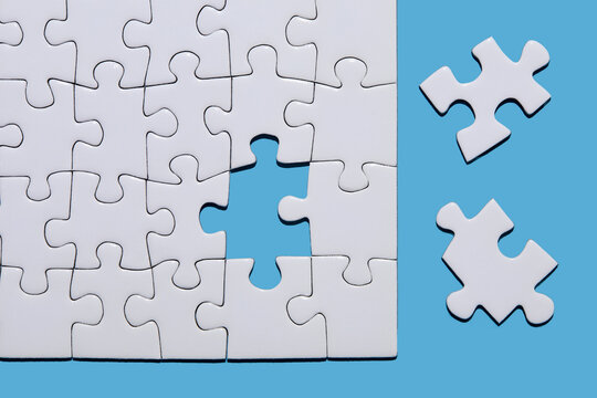 Blank puzzle pieces on blue background - Powered by Adobe
