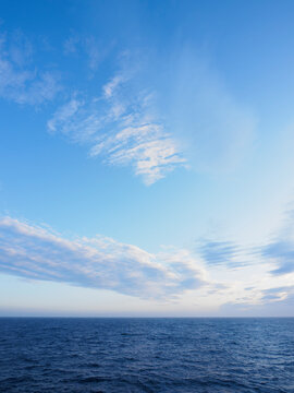 Wispy clouds above sea