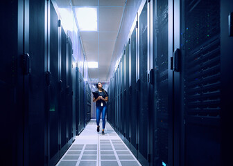 Female technician walking in server room