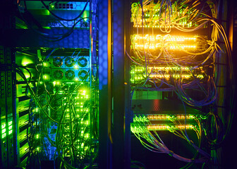 Close-up of hard drives and cables in data center