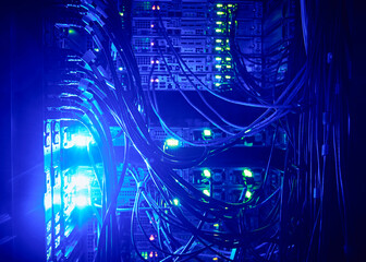 Close-up of hard drives and cables in data center