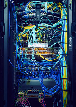 Close-up of hard drives and tangled cables in data center