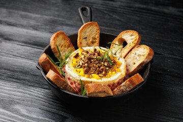 Baked Camembert cheese with mango and pistachio