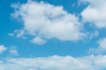 Large scattered white clouds on a blue sky above