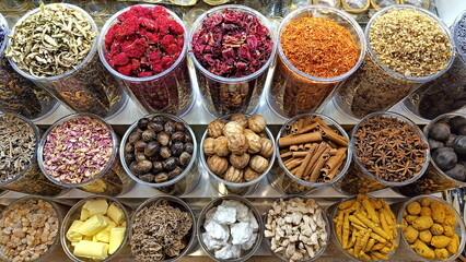Various spices and herbs in transparent containers in a Dubai store.