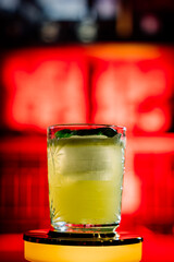 Focus on a glass with a beautiful tasty cocktail