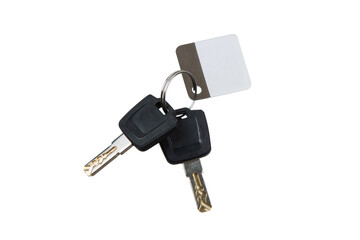 A set of two car keys with black plastic heads attached to a metal keyring, accompanied by a blank white and brown key tag, isolated on a white back