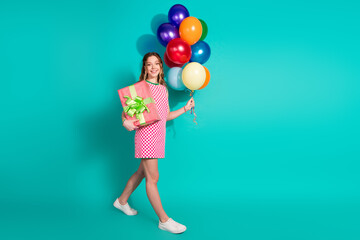 Fototapeta premium Full body photo of attractive teen woman birthday air balloons present dressed checkered pink clothes isolated on cyan color background