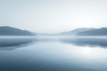 Fototapeta premium Light fog covering lake and forest at sunrise creating concentric ripples