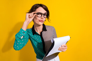 Photo of charming minded woman wear stylish clothes hold contract isolated on yellow color...