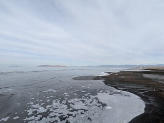 Stunning View of the Great Salt Lake with Reflective Waters Under a Cloudy Sky.