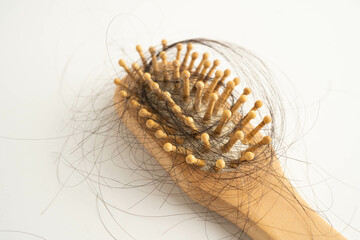 Hair loss fall with comb brush isolated on white background.