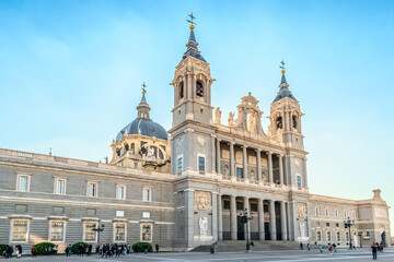Almudena Cathedral in Madrid, showcasing its neoclassical architectural style with twin bell towers...