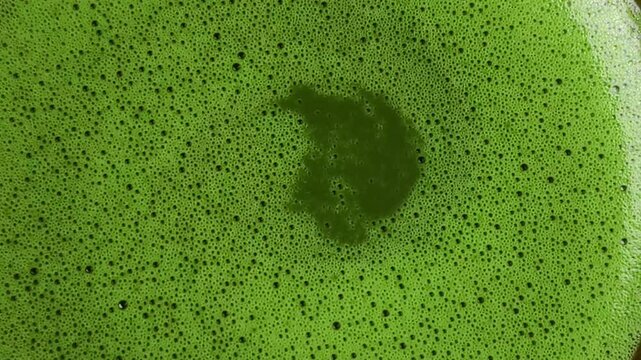 Close-up capturing detailed features of green tea with a smooth