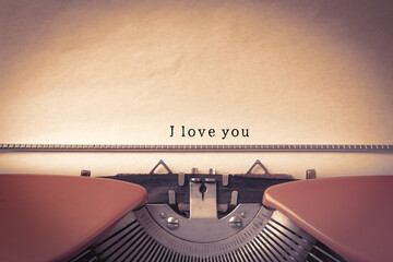 Typewriter with sheet of paper, closeup. Typed text I Love You