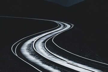 Curved railway tracks at night illuminated moonlight