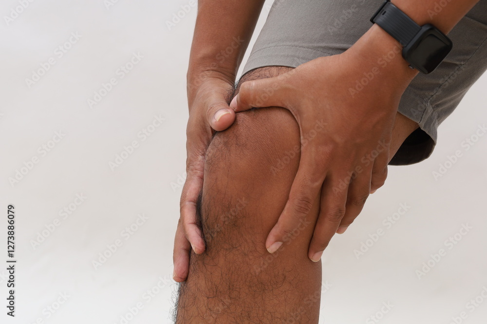 Wall mural Close up photo of a man holding his knees