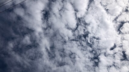 Clouds cumulus cloudscape, white fluffy, scenic sunlight, climate on clear blue sky, selective focus. Ant's view. Natural background. © praditkhorn