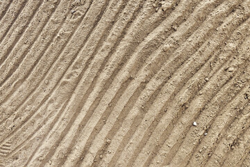 Beach sand pattern as background with natural wave. Natural sand beach sand texture in summer sun. Top view.