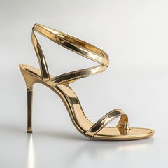 Elegant golden stiletto heel sandal with ankle strap, a glamorous fashion statement, perfect for special occasions and stylish outfits in a studio setting