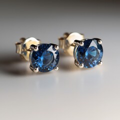 Elegant pair of sapphire earrings with gold setting, showcasing the beauty of blue gemstones, designed for women and girls, luxurious accessories for special occasions.