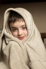 Child wrapped in a soft, cozy blanket, creating a sense of warmth and comfort. Perfect for themes of relaxation, childhood, and care.