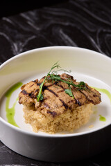 Deliciously Grilled Chicken Infused with Fresh Herbs Presented on a Minimalist Plate Design