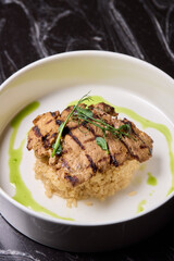 Deliciously Grilled Chicken Infused with Fresh Herbs Presented on a Minimalist Plate Design