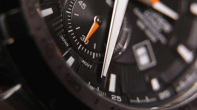 Ticking Clock face with moving hands on a quartz watch with chronograph
