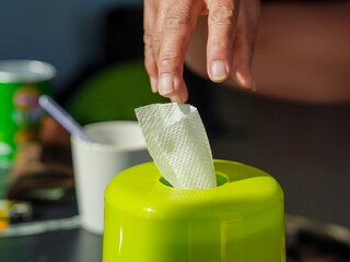 Lifestyle Health care. Close-up of people's hands taking out tissue paper from the box to use....