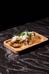 A Mouthwateringly Delicious Gourmet Dish Impeccably Served on a Rustic Wooden Plate