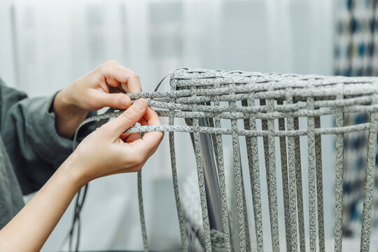 rattan furniture, a woman makes an artificial rattan chair. handmade