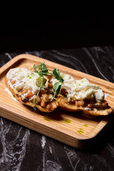 A Mouthwateringly Delicious Gourmet Dish Impeccably Served on a Rustic Wooden Plate