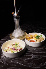 Indulge in an exquisite hookah experience accompanied by a selection of gourmet dishes to savor
