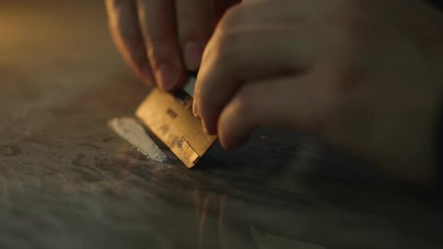 a man with a credit card makes himself a shot of heroin.
Drug addiction.
The man uses drugs.
Drugs on the table.
Drugs, addiction, heroin, ecstasy, morphine