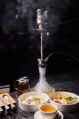 Indulge in an exquisite hookah experience accompanied by a selection of gourmet dishes to savor