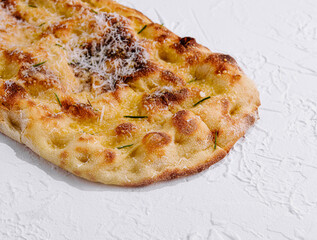 Freshly baked cheesy flatbread on white background