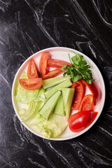 Delicious and Fresh Vegetable Salad featuring Crisp Lettuce, Juicy Tomatoes, and Cool Cucumbers