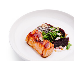 Grilled salmon with beetroot salad garnished with almonds