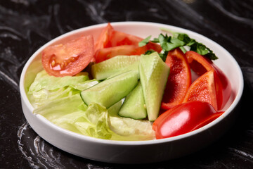 Delicious and Fresh Vegetable Salad featuring Crisp Lettuce, Juicy Tomatoes, and Cool Cucumbers