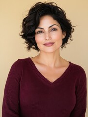 Obraz premium Portrait of a confident young hispanic female with short curly hair and maroon sweater.