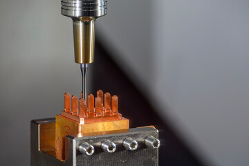 The CNC milling machine cutting the copper electrode parts by solid ball nose end mill tools.