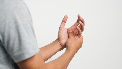 Fototapeta premium Young man holding both hands. Arm area pain. Hand soreness and tingling concept