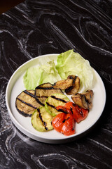 Delicious Grilled Vegetables Salad Served with a Variety of Fresh Greens on a Vibrant Plate