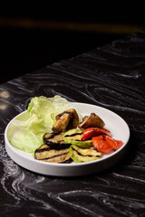 Delicious Grilled Vegetables Salad Served with a Variety of Fresh Greens on a Vibrant Plate