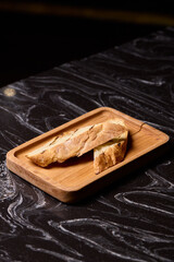 Artisan Biscotti arranged beautifully on a Wooden Plate set against a Dark Background