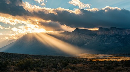 Dramatic Sunrise Over Majestic Mountains and Cloudy Sky