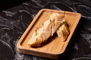 Artisan Biscotti arranged beautifully on a Wooden Plate set against a Dark Background