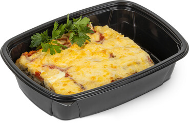 A black container filled with food, topped with fresh parsley