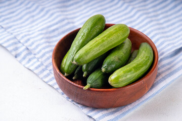 Tasty raw organic mini baby cucumbers, micro one bite cucumbers, for finger food and sandwiches, on...
